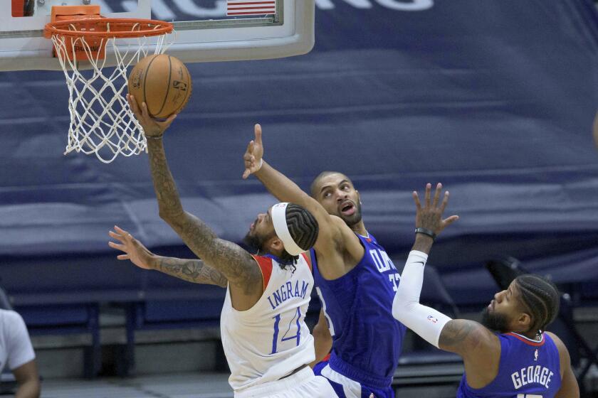 New Orleans Pelicans forward Brandon Ingram (14) shoots agains Los Angeles Clippers forward Nicolas Batum (33) in the first half of an NBA basketball game in New Orleans, Sunday, March 14, 2021. (AP Photo/Matthew Hinton)