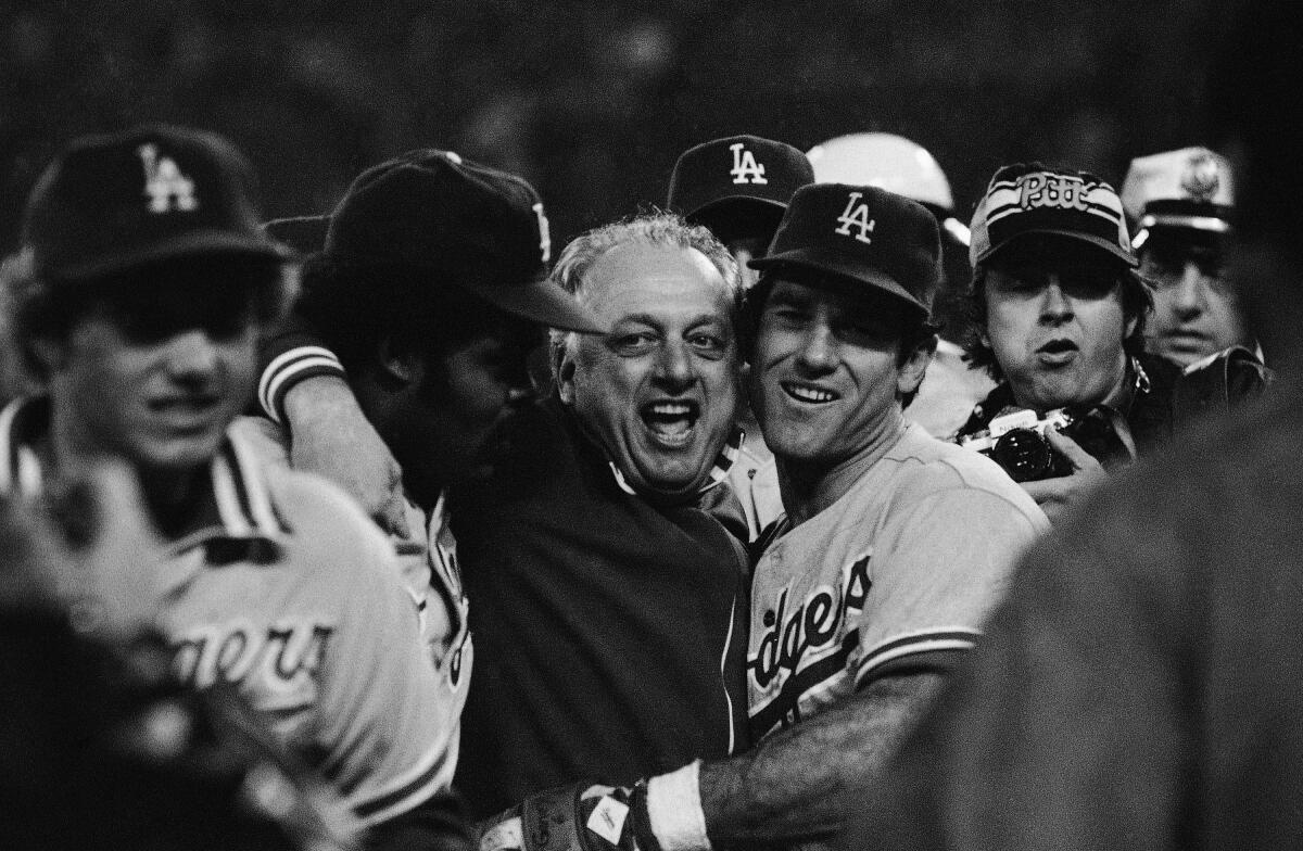 Steve Garvey and Tommy Lasorda embrace after the Dodgers beat the Phillies in the 1977 NLCS.