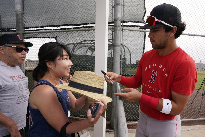 Boston Red Sox's Marcelo Mayer signs autographs during baseball spring training at Jet Blue Park Wednesday March 16, 2022, in Fort Myers, Fla. (AP Photo/Steve Helber)