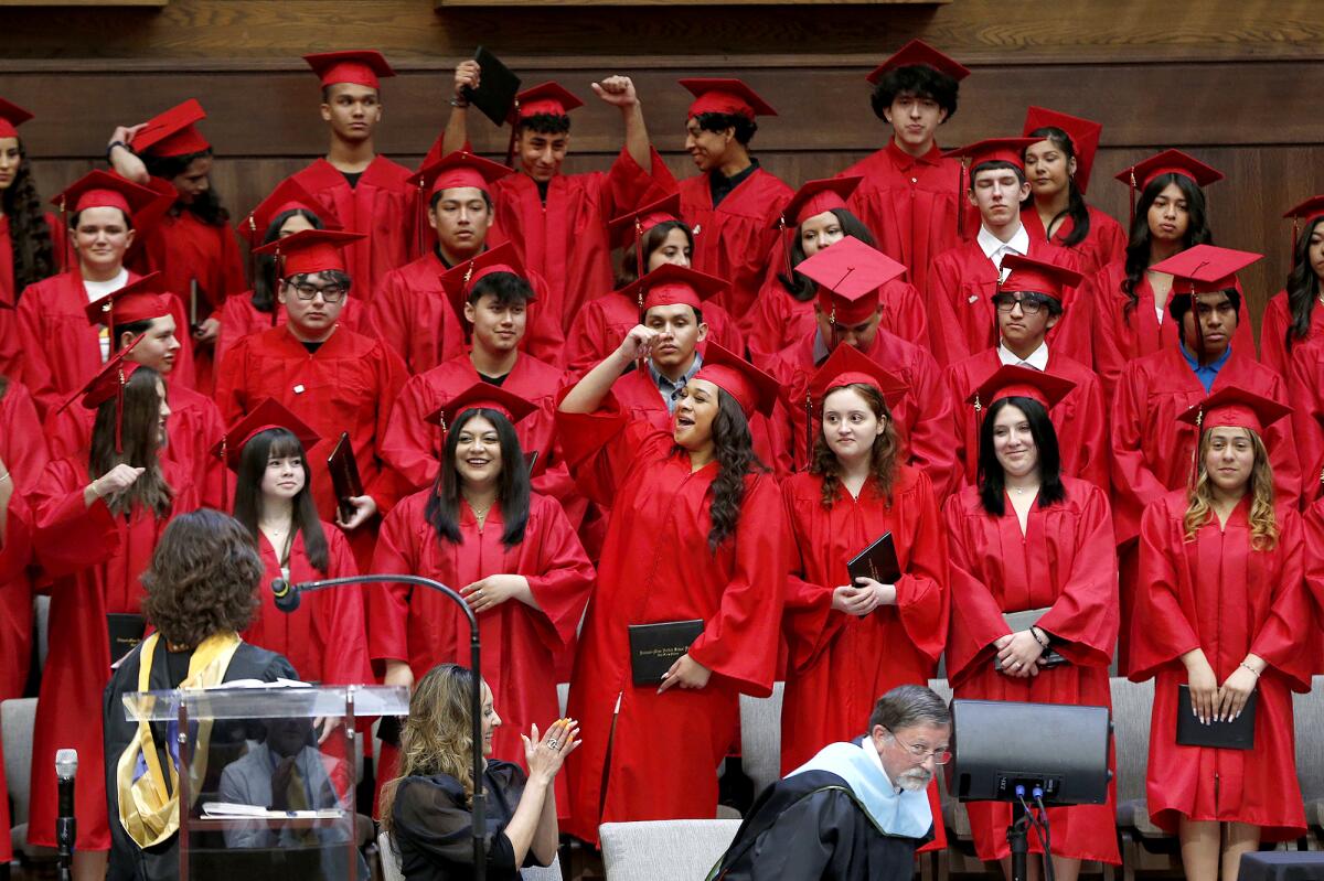 Back Bay/Monte Vista seniors Thursday cheer as their matriculation from the continuation/independent school is announced.