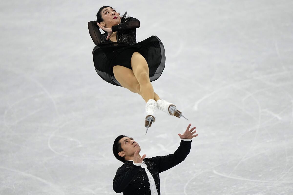 Sui Wenjing and Han Cong of China compete in the figure skating pairs short program.