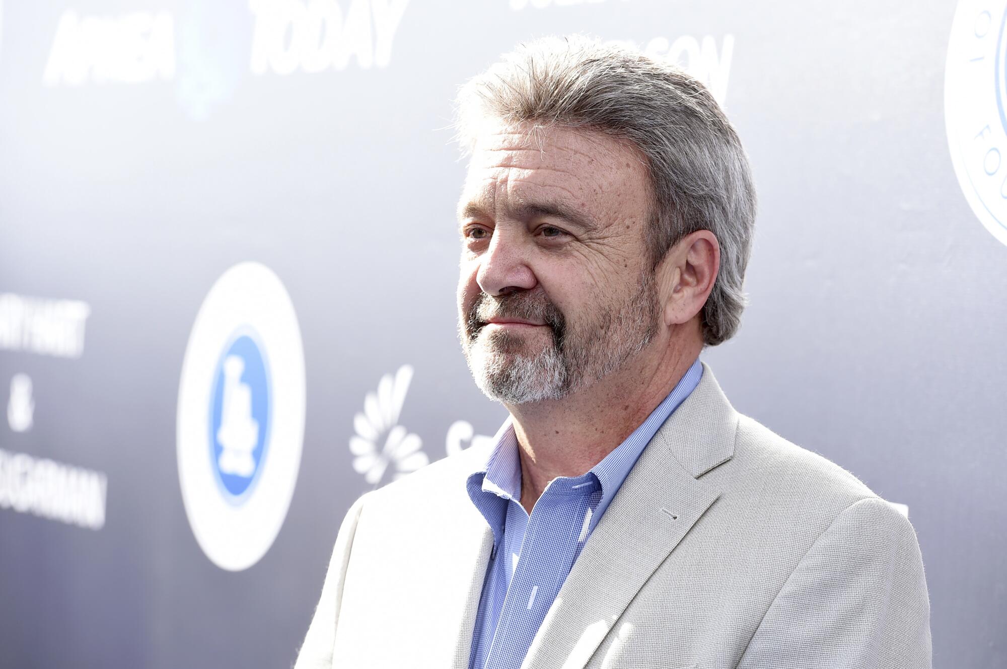 Former Dodgers general manager Ned Colletti stands on a red carpet in 2017.