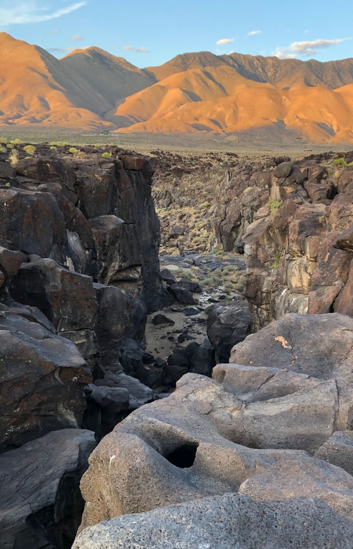 A "fossilized" waterfall near mountains.