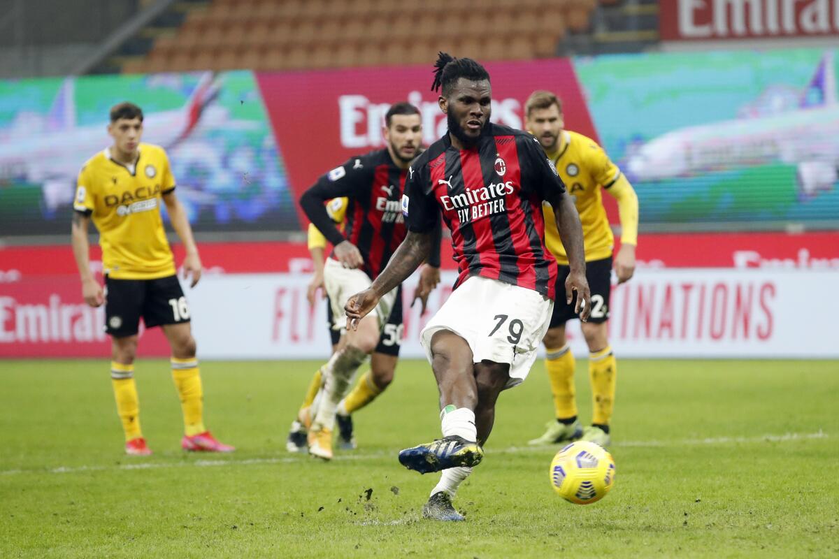 AC Milan midfielder Franck Kessie (79) scores the penalty spot during the Serie A soccer match between AC Milan and Udinese at the San Siro stadium, in Milan, Italy, Wednesday, March 3, 2021. (AP Photo/Antonio Calanni)