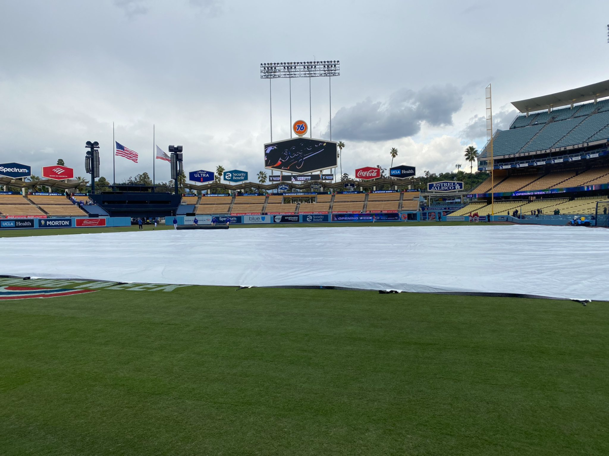 The infield at Dodger Stadium is covered by a tarp hours before the team's season opener on Thursday.
