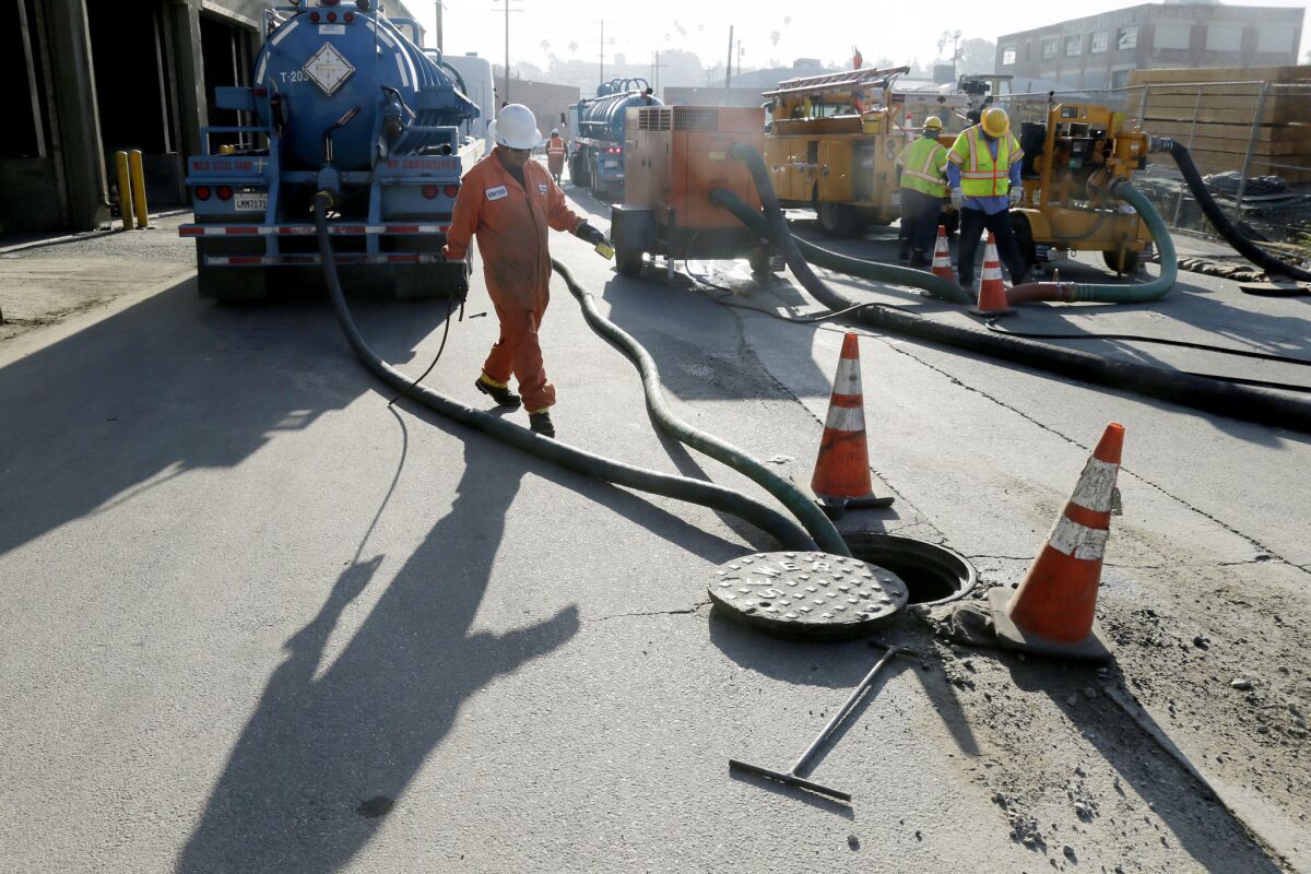 Repair work is underway July 19 after a sewage spill at Mission Road and 6th Street in Boyle Heights.