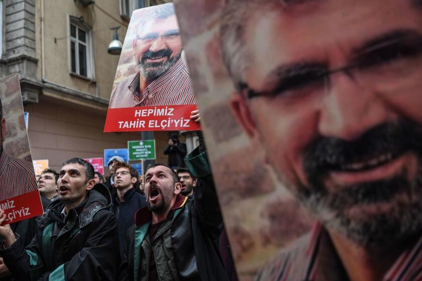 People attend a demonstration holding hold portraits of Tahir Elci, a former president of Diyarbakir Bar Assosation killed in 2015, during a protest entitled "the day of endangered Lawyers" on January 24, 2019 at the Istklal avenue in central Istanbul. (Photo by OZAN KOSE / AFP)OZAN KOSE/AFP/Getty Images ** OUTS - ELSENT, FPG, CM - OUTS * NM, PH, VA if sourced by CT, LA or MoD **