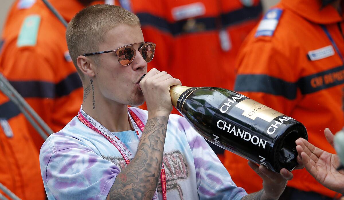 Justin Bieber drinks Champagne after British Formula One driver Lewis Hamilton won the Monaco Formula One Grand Prix on Sunday.