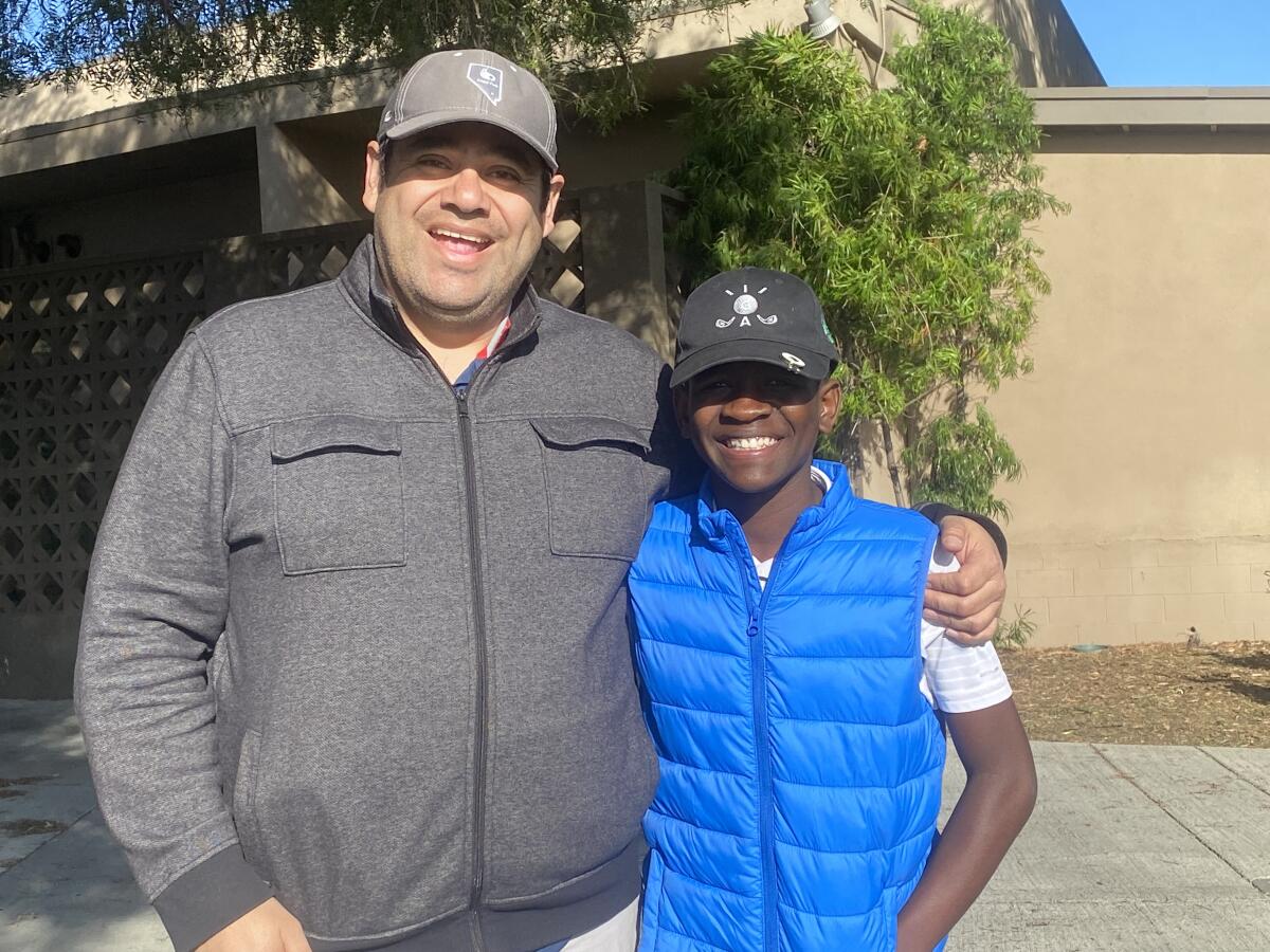 Eddie Campa and his son Pierre pose for a photo.