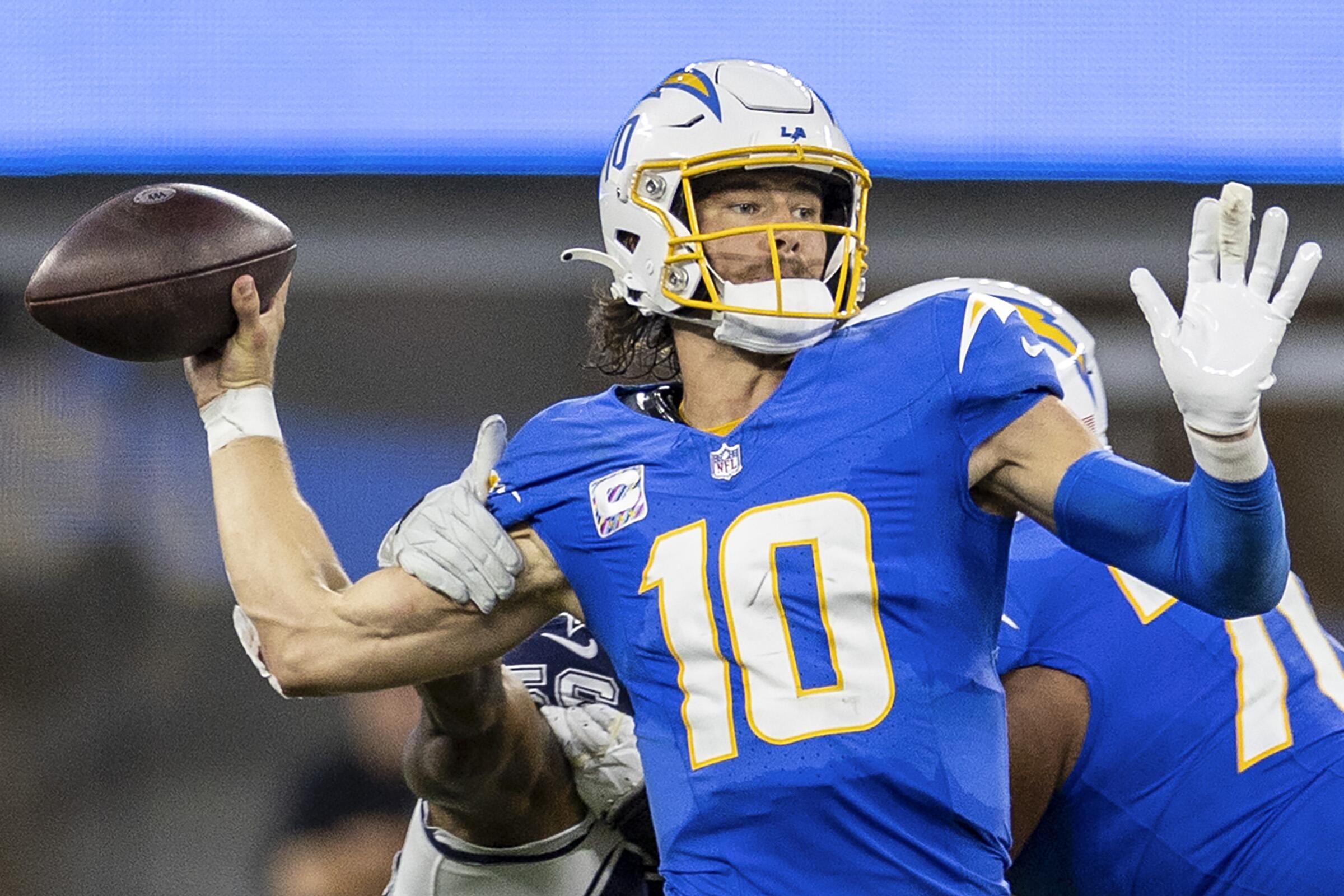  Chargers quarterback Justin Herbert attempts to throw the football.