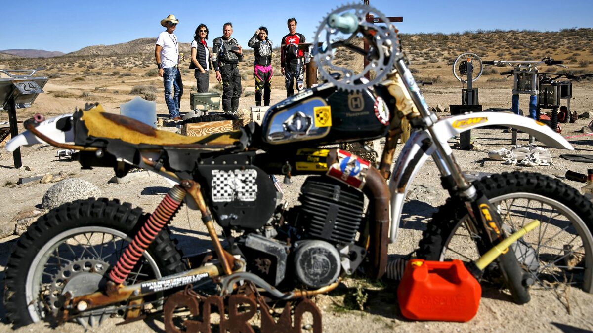 Family and friends of the late Bill Tuchscher gather late last year to honor their fallen rider at a remote Mojave Desert location known as the Husky Memorial.