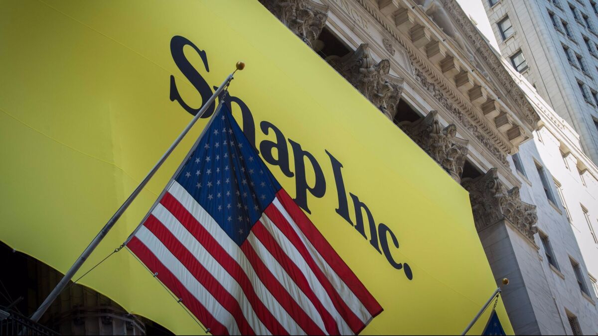 A banner for Snap Inc. is hung outside the New York Stock Exchange on March 2, the day the tech company started trading publicly.