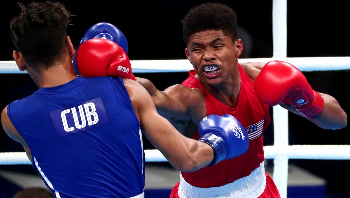American boxer Shakur Stevenson trades punches with Cuba's Robeisy Ramirez during their gold-medal bout Saturday.