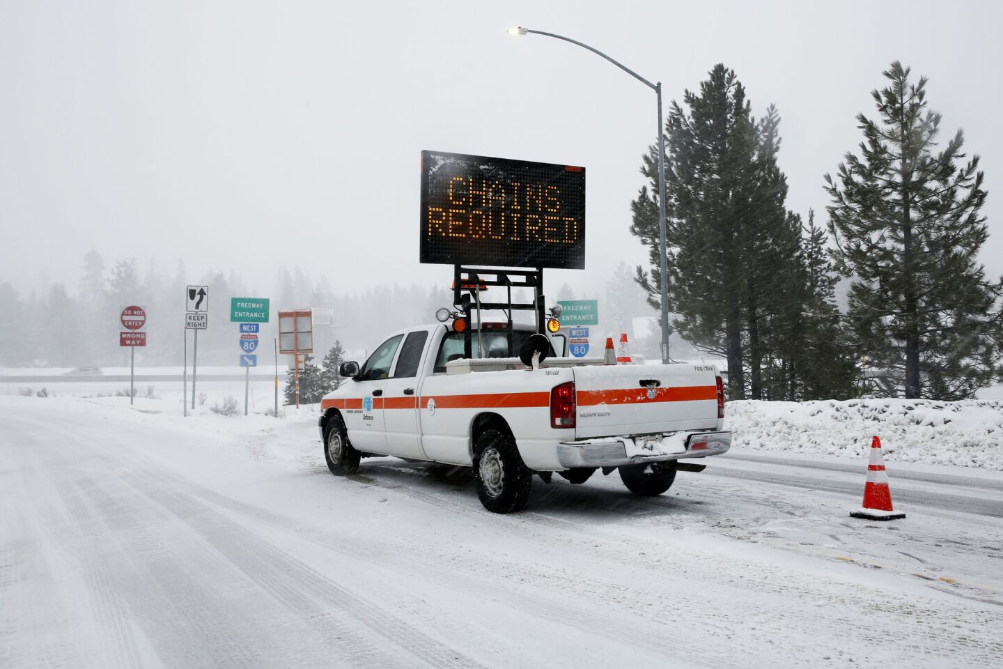 On a snowy day, a sign makes it clear that chains are required on this stretch of Interstate 80 in Truckee.