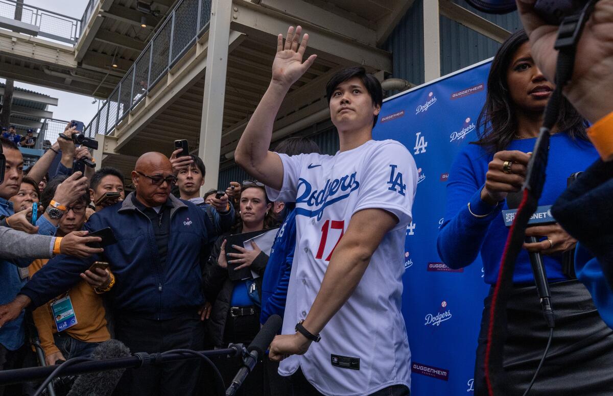 Dodgers star Shohei Ohtani waves to fans at the team's fanfest at Dodger Stadium.