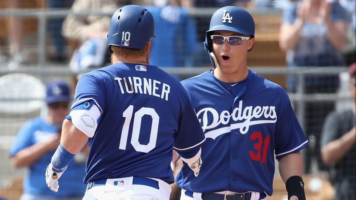 Dodgers' Joc Pederson celebrates with Justin Turner during a spring-training game at Camelback Ranch in Phoenix.