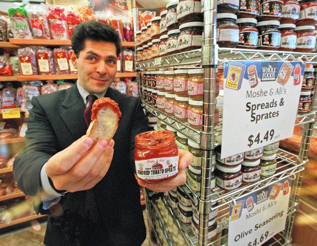 Entrepreneur Daniel Lubetzky, shown in 1997, holds up a sample of sun-dried tomato spread. He has since moved on to found and build Kind Healthy Snacks.