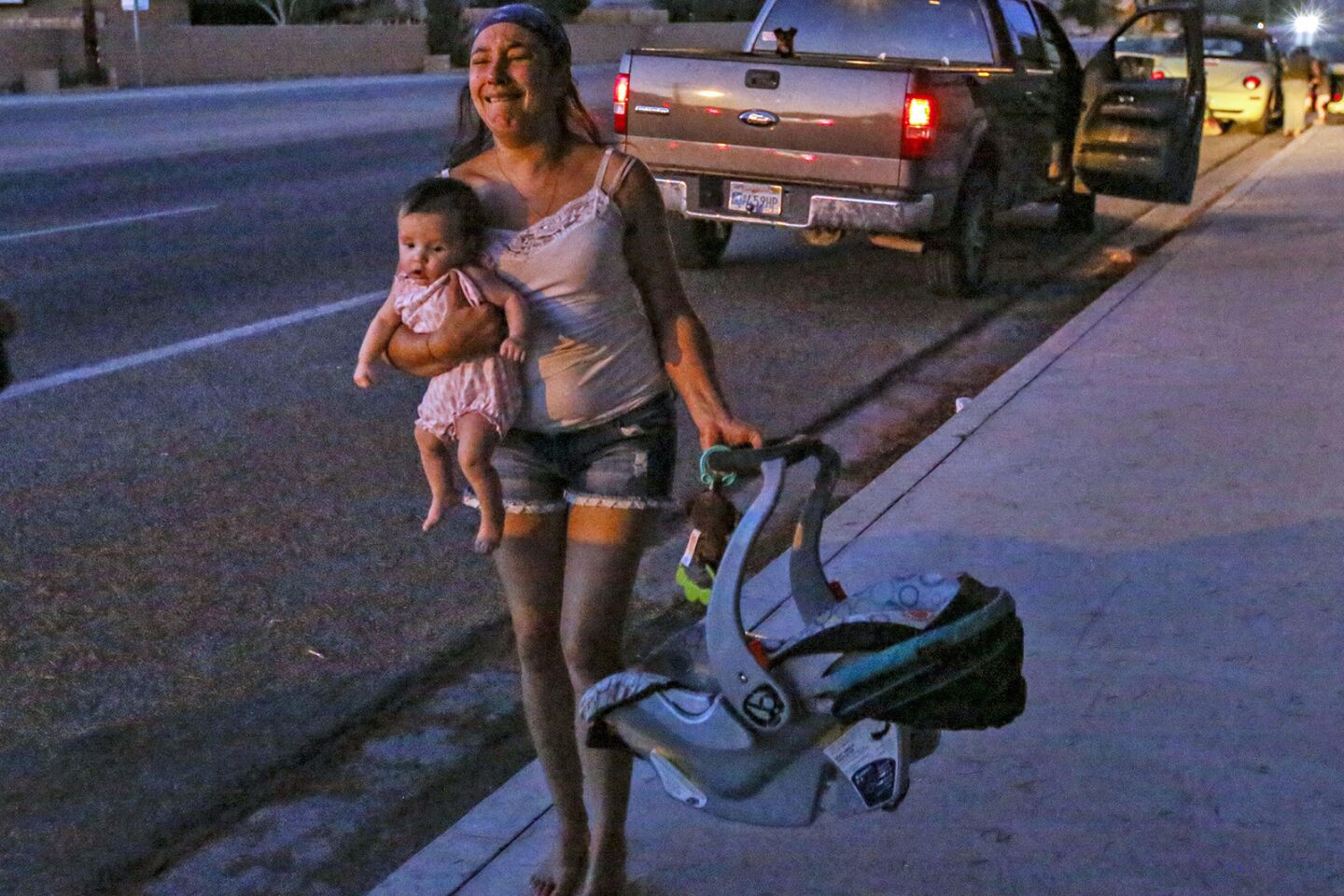 Dawn Inscore leaves her apartment on Ridgecrest Boulevard with her child after the Friday night earthquake.
