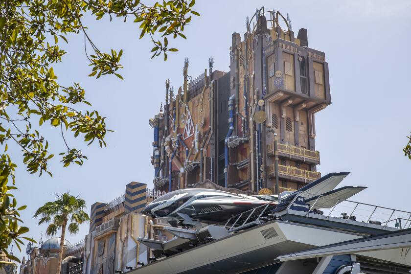 A Quinjet rests high atop the Avengers Headquarters building at California Adventure.
