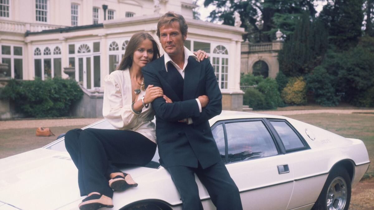 1977: Barbara Bach and Roger Moore, stars of the James Bond movie "The Spy Who Loved Me," leaning on the now-famous "amphibious" Lotus Esprit.