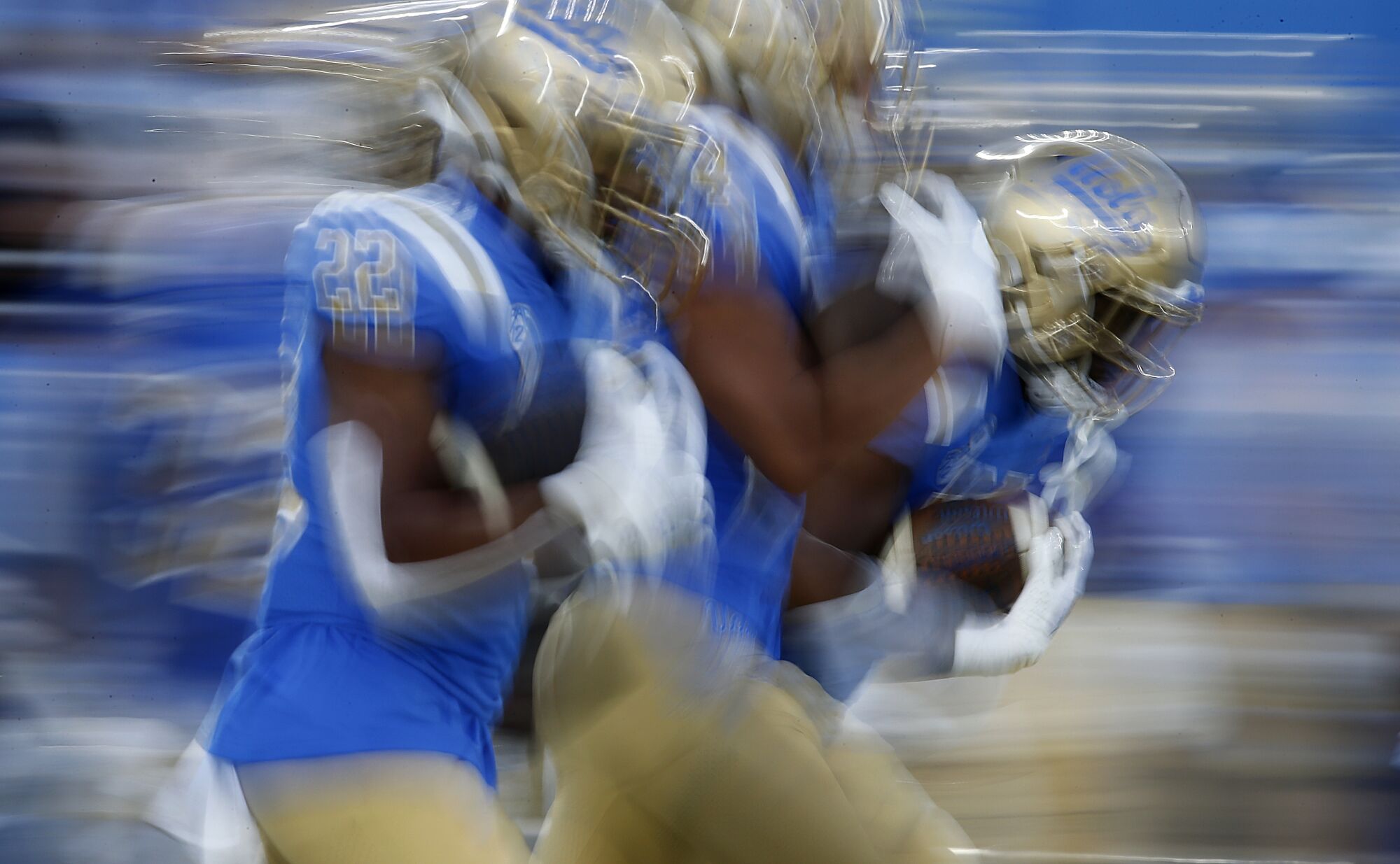 UCLA running backs warm up before playing against USC.