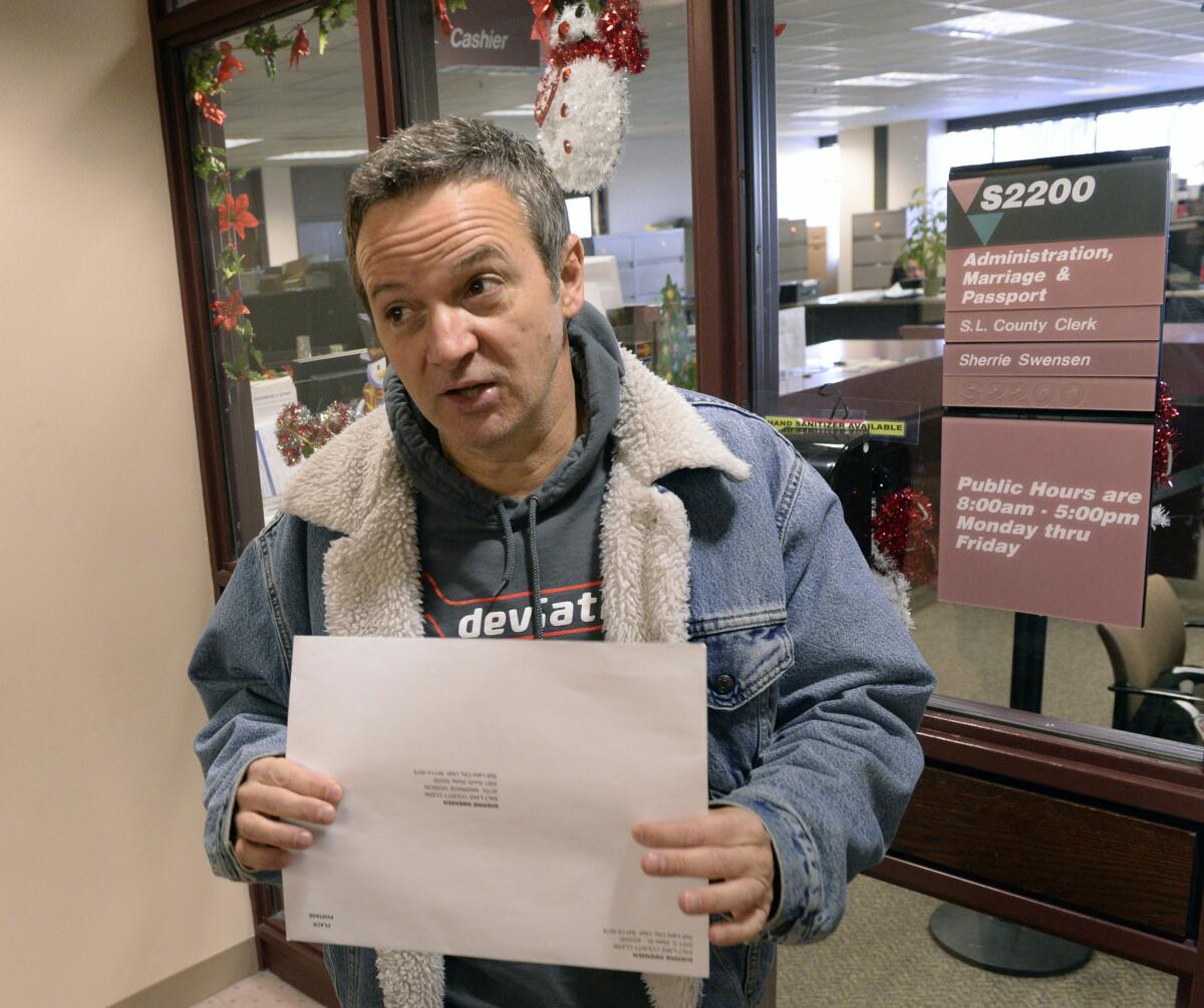 Michael Braxton, who legally performed a marriage for a same sex couple on Saturday arrives at the Salt Lake County Clerks office Monday to register the marriage certificate a few minutes after the Supreme Court issued a stay to Utah's gay marriage ruling.