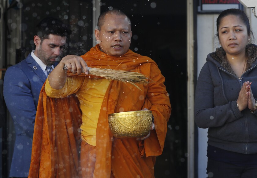 Buddhist monk performs a cleansing ritual in Long Beach.