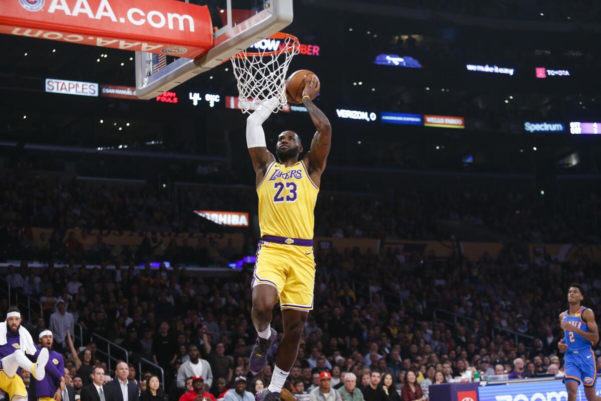 Los Angeles Lakers' LeBron James (23) dunks against Oklahoma City Thunder during the first half of an NBA basketball game, Tuesday, Nov. 19, 2019, in Los Angeles. (AP Photo/Ringo H.W. Chiu)