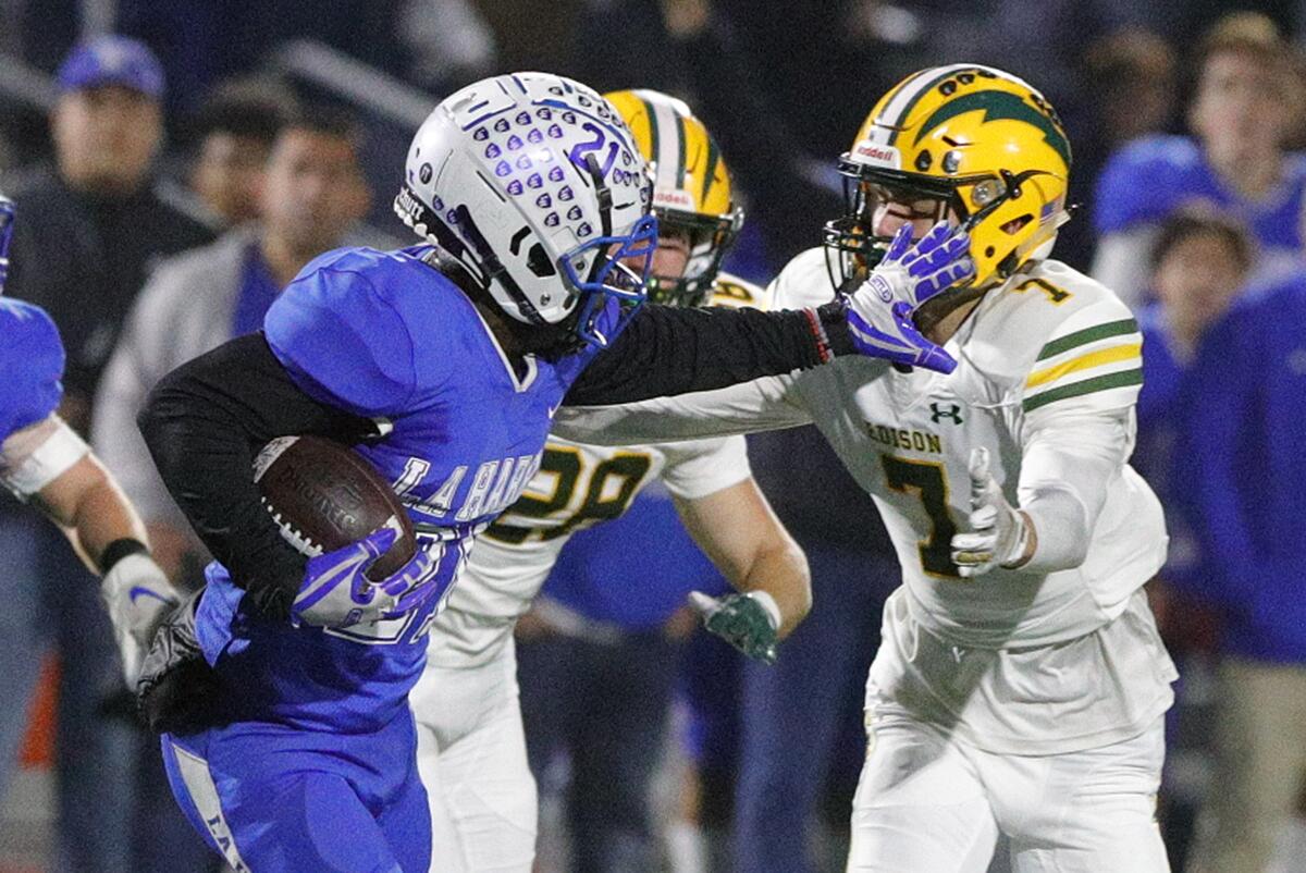 La Habra's Clark Phillips III stiff-arms Edison's Gavin Chiavetta while taking a kickoff return 90 yards for a touchdown in the second quarter of the CIF Southern Section Division 3 quarterfinal in La Habra on Friday.