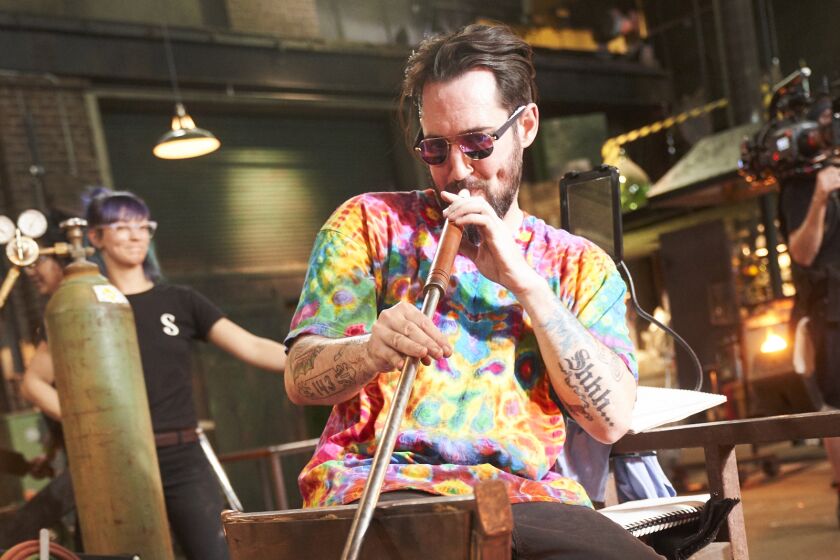 Artist Mike Shelbo in the process of glassblowing