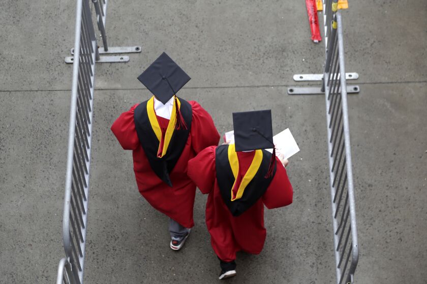 FILE - In this May 13, 2018, file photo, new graduates walk into the High Point Solutions Stadium before the start of the Rutgers University graduation ceremony in Piscataway Township, N.J. Colleges across the U.S. have begun cancelling and curtailing spring graduation events amid fears that the new coronavirus will not have subsided before the stretch of April and May when schools typically invite thousands of visitors to campus to honor graduating seniors. (AP Photo/Seth Wenig, File)