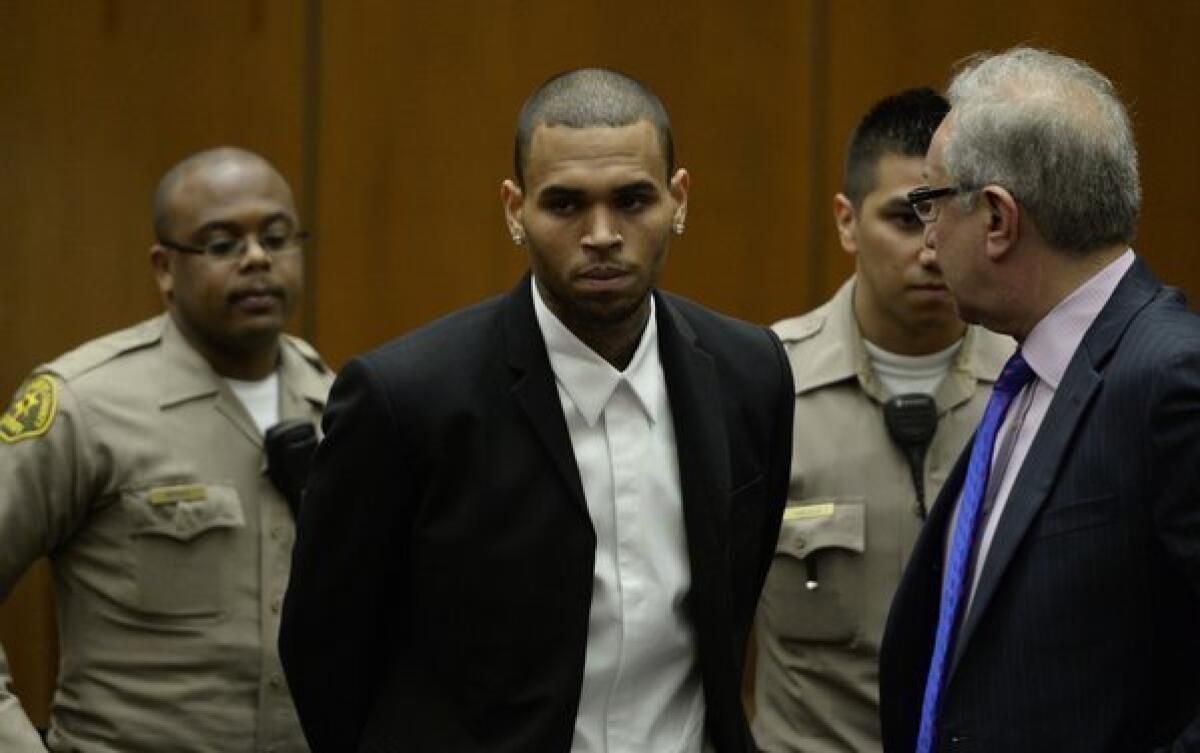 R&B; singer Chris Brown, center, arrives in court. At right is his lawyer, Mark Geragos.