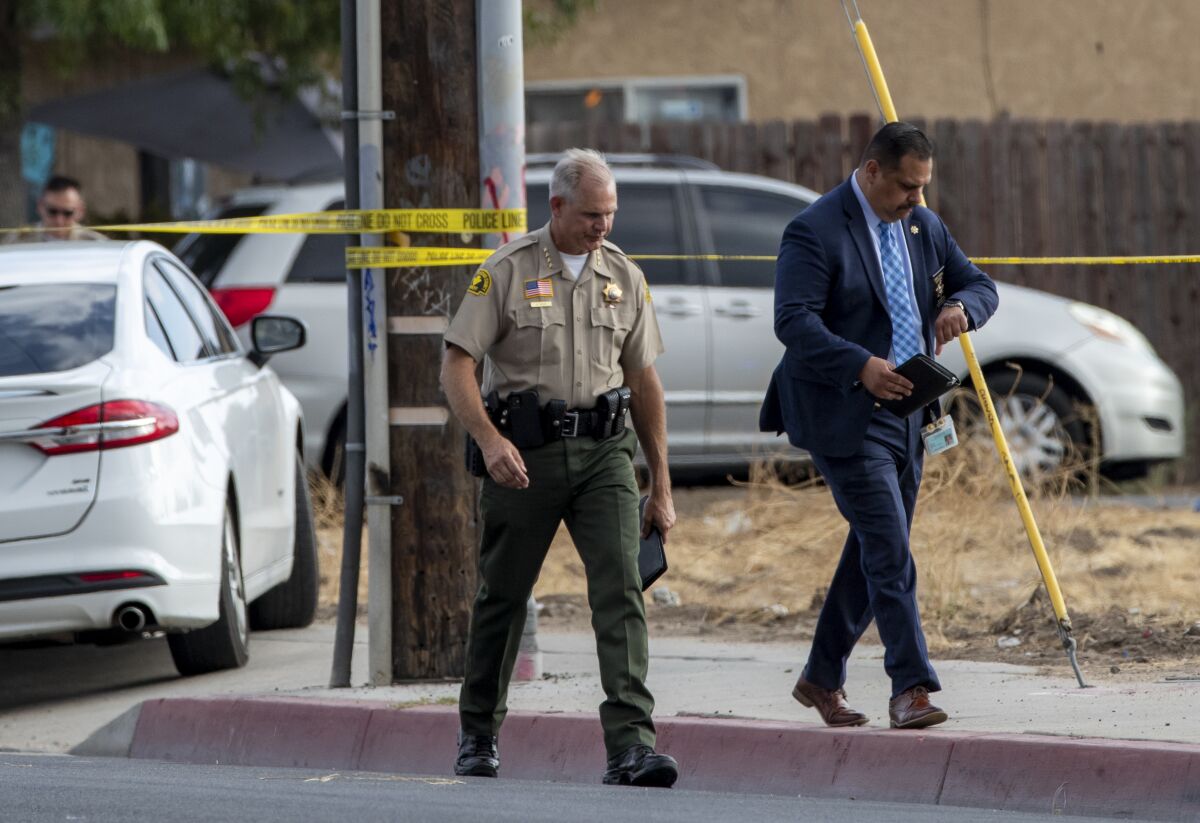 San Bernardino County Sheriff Shannon Dicus leaves the scene of a shootout in Highland in 2021. 