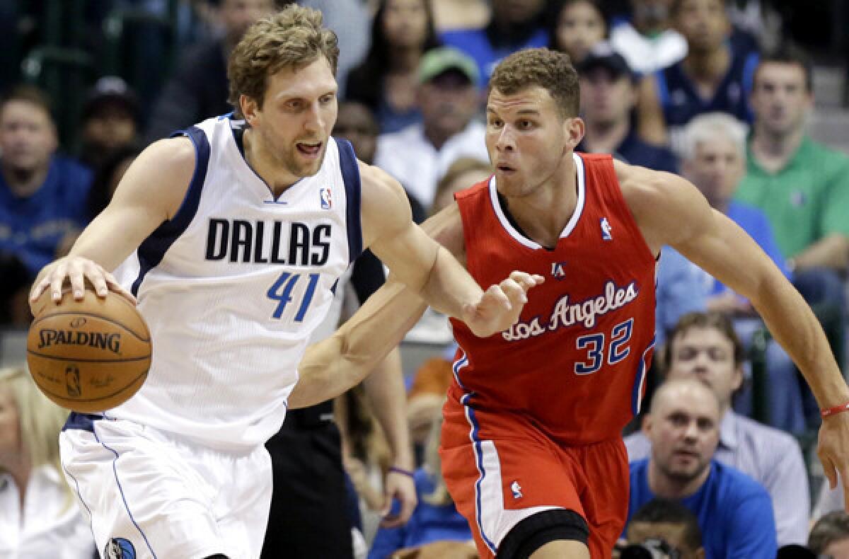Clippers power forward Blake Griffin tries to cut off a drive by Mavericks power forward Dirk Nowitzki during their game Thursday night in Dallas.