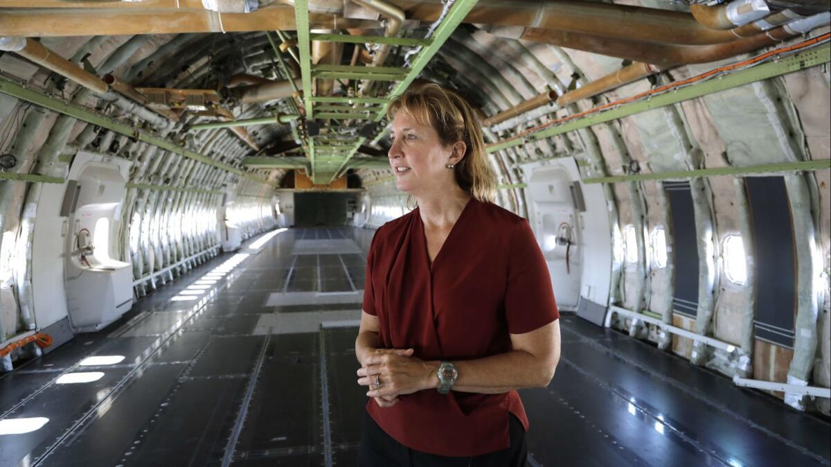 Kelly Latimer inside the gutted fuselage of "Cosmic Girl," the modified 747 plane that is set to launch rockets from beneath its wing.