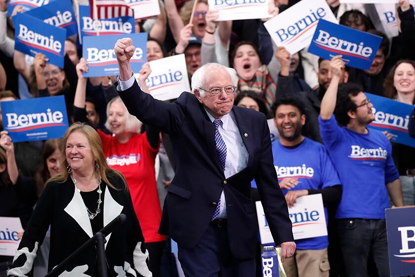 Democratic presidential candidate Bernie Sanders and his wife Jane O'Meara Sanders celebrates with supporters in Manchester, N.H., on Tuesday.