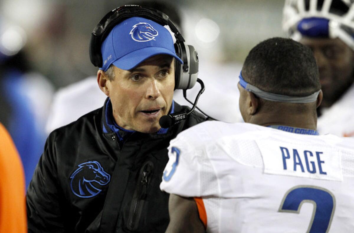 Boise State Coach Chris Petersen talks to defensive back Cleshawn Page during a game against Colorado.