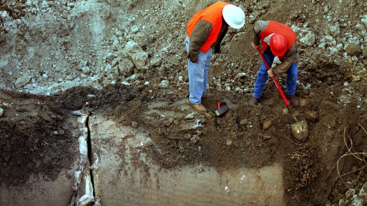 MWD workers inspect a water main days after it exploded in December 1999, shutting down service to as many as 700,000 Orange County residents.