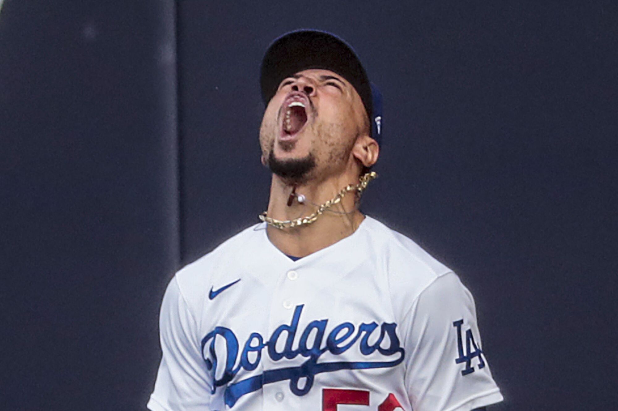Dodgers right fielder Mookie Betts celebrates after makes a leaping catch on a ball hit by Atlanta's Marcell Ozuna.