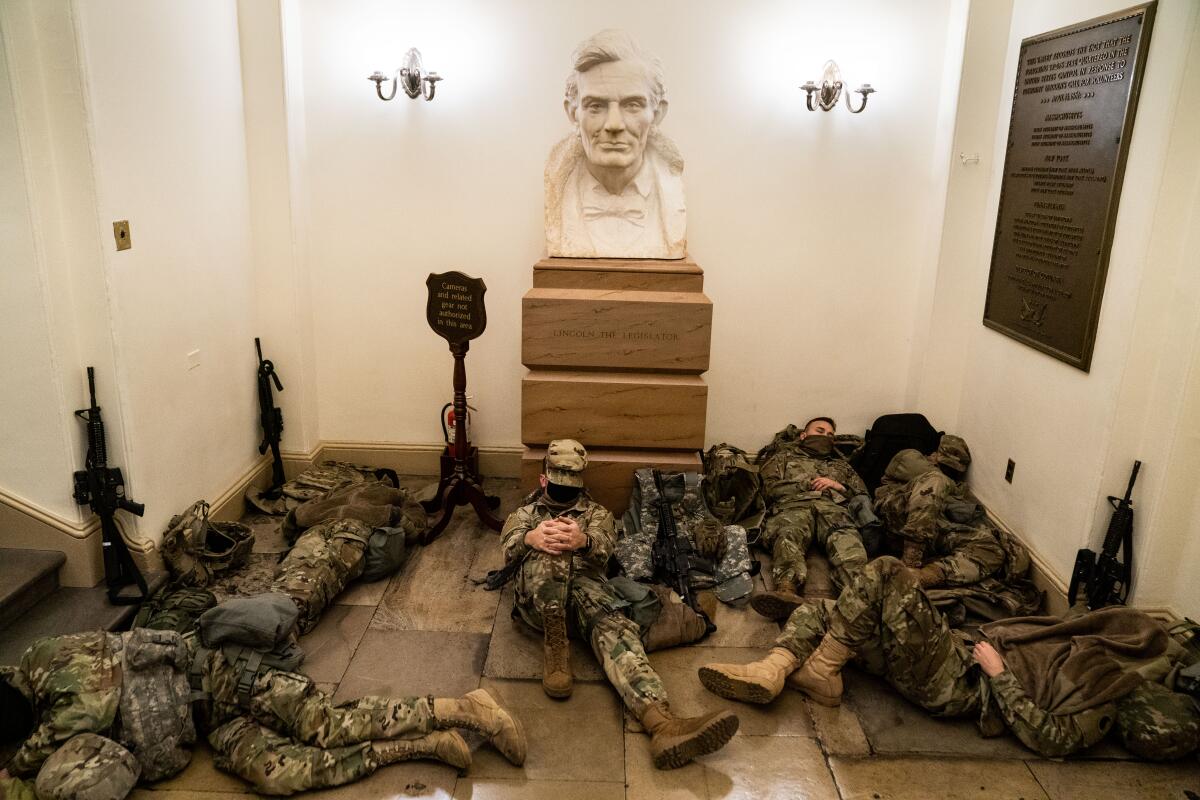 National Guard members sleep on the floor of the U.S. Capitol