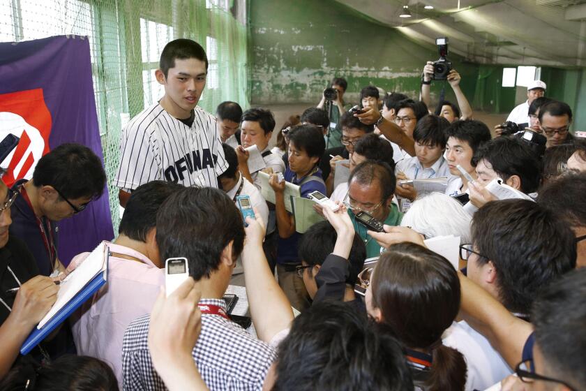 Highly touted Roki Sasaki of Ofunato high school speaks to reporters after pitching in a regional tournament game against Tono Ryokuho on July 16, 2019, in Hanamaki, Iwate Prefecture, northeastern Japan. Many scouts compare Sasaki to Shohei Ohtani of the Los Angeles Angels.