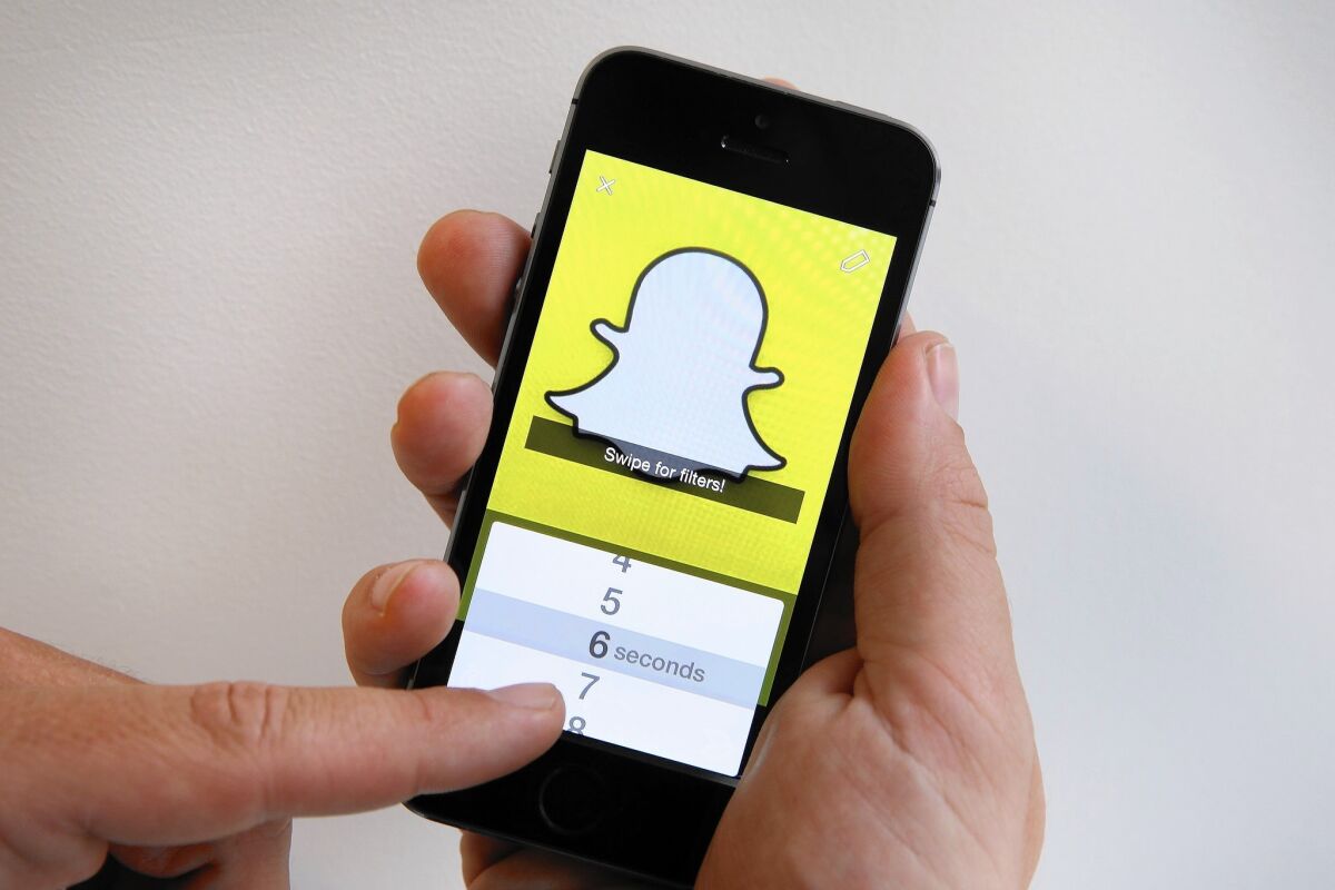 The Snapchat app is used on an iPhone in London. Content shared on Snapchat automatically erases itself after a limited time unless a user specifically saves it.