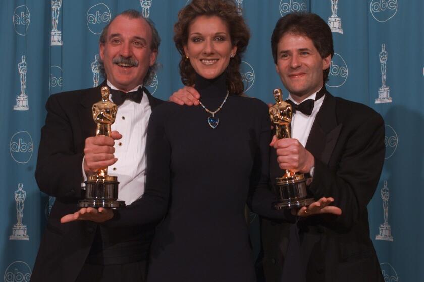 Will Jennings, left, Celine Dion and James Horner at the 70th Academy Awards at the Shrine Auditorium in Los Angeles in 1998.