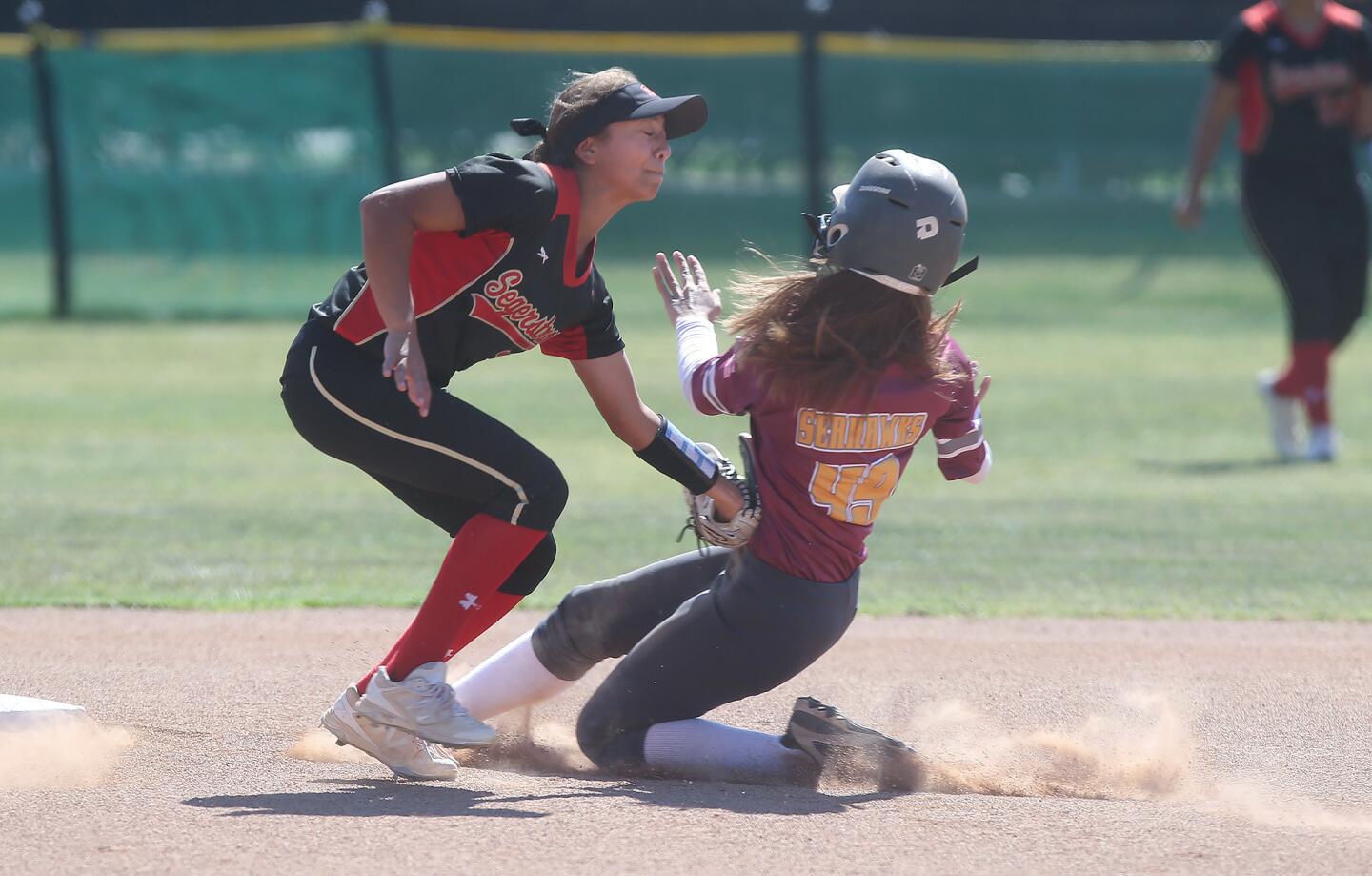 Ocean View High's Ari Hencke is tagged out trying to steal second base by Segerstrom's Rebeca Cabezas in a Golden West League game at Segerstrom on Wednesday.