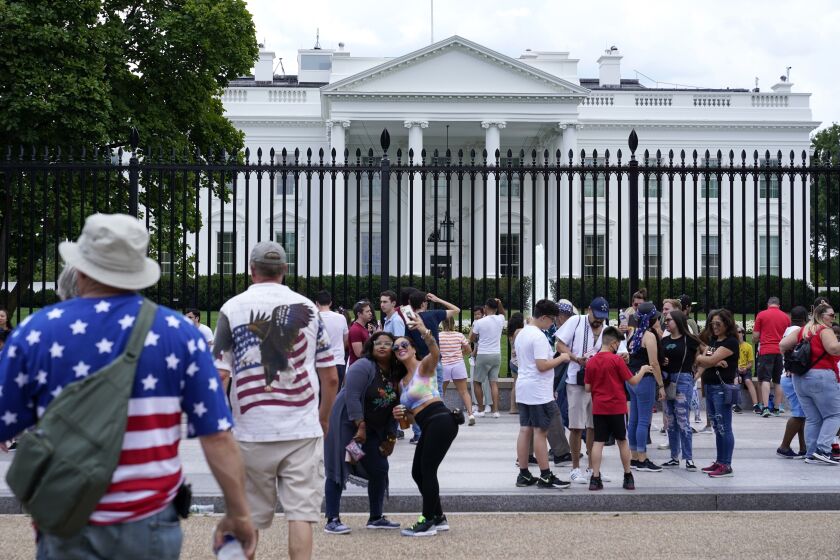 People gather on a section of Pennsylvania Avenue that was reopened to the public in front of the White House, Sunday, July 4, 2021, in Washington. (AP Photo/Patrick Semansky)
