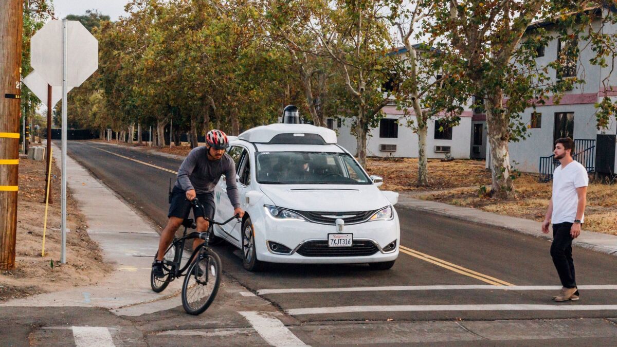 Waymo tests its driverless Chrysler Pacifica minivans at its facility in Atwater, Calif.