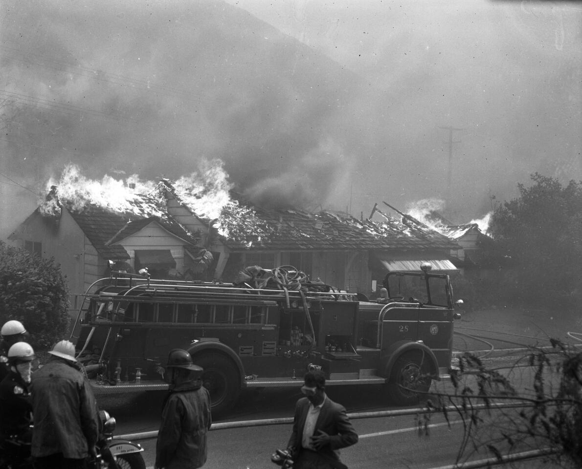 Nov. 6, 1961: Firefighters with a truck aren't enough to save a home on Roscomare Road in Bel-Air. This image appeared in the Nov. 7, 1961, Los Angeles Times.