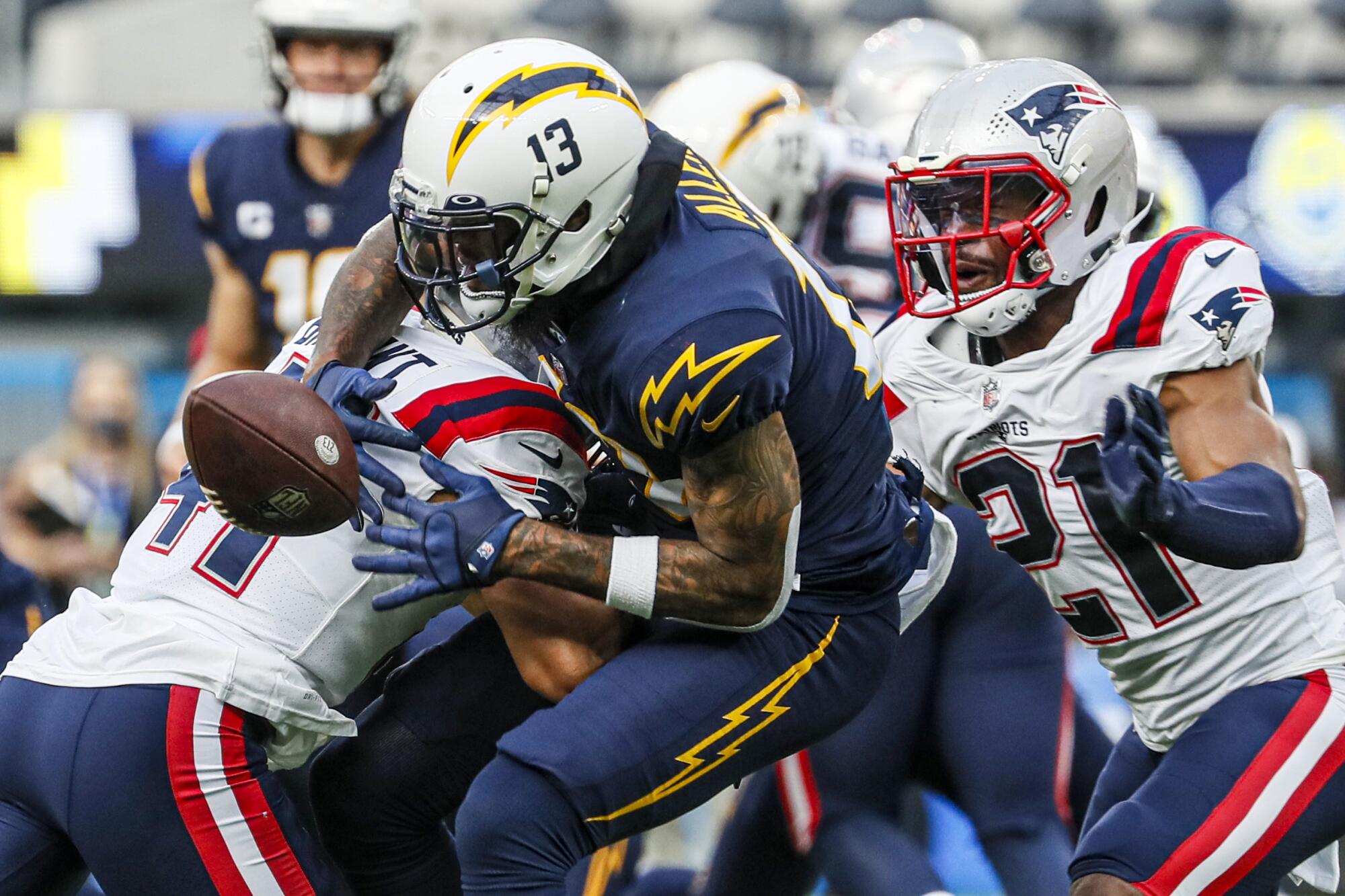 Chargers wide receiver Keenan Allen can't make a catch as he's hit by New England Patriots cornerback Myles Bryant.