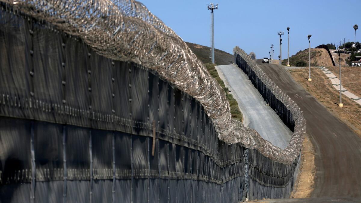 A Border Patrol agent patrols along the secondary fence along the U.S.-Mexico border with Tijuana in San Diego.