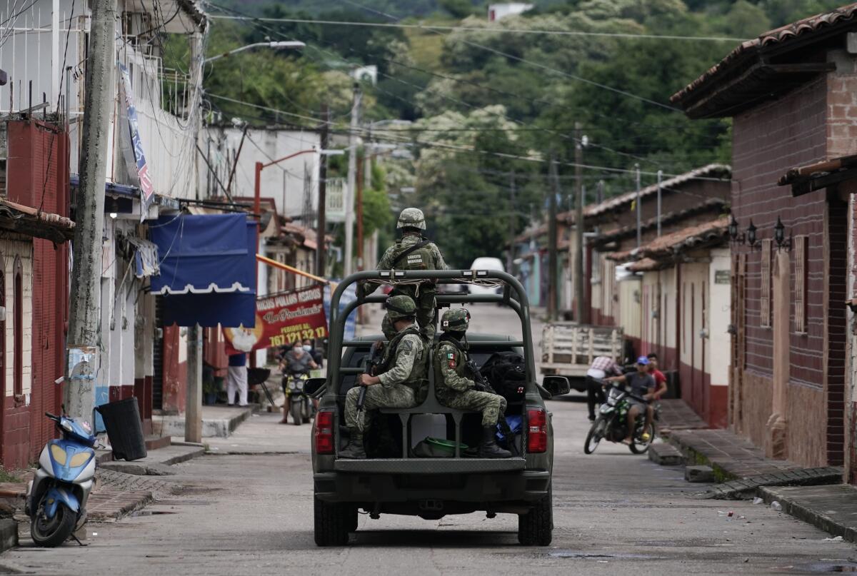 Soldiers patrol a neighborhood in Mexico.